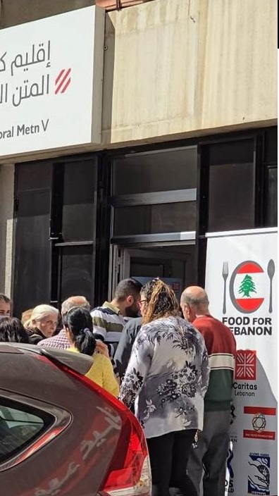 Description: A group of people standing outside a building  AI-generated content may be incorrect.